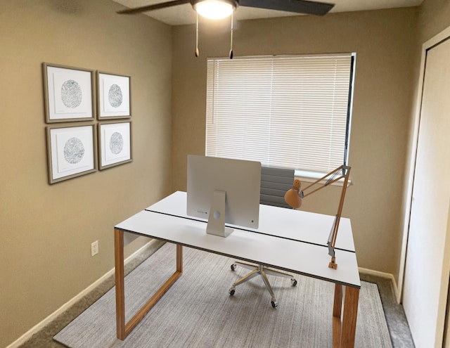 carpeted home office with ceiling fan