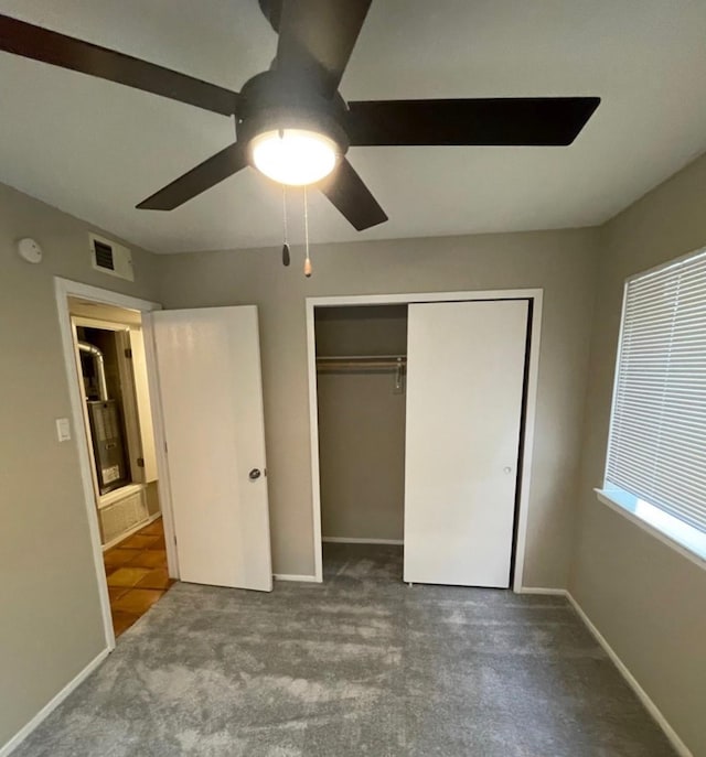 unfurnished bedroom with carpet, ceiling fan, and a closet