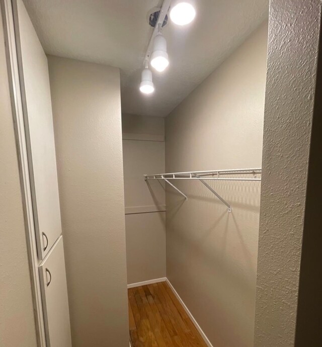 spacious closet featuring hardwood / wood-style floors