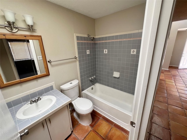 full bathroom featuring tasteful backsplash, toilet, tiled shower / bath, and sink