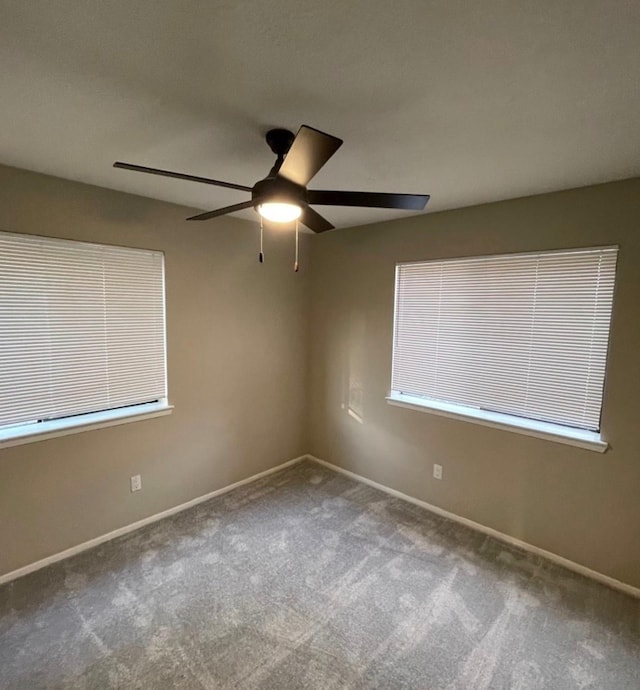 carpeted empty room featuring ceiling fan and a healthy amount of sunlight