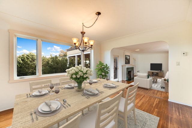 dining space featuring a notable chandelier and dark hardwood / wood-style floors