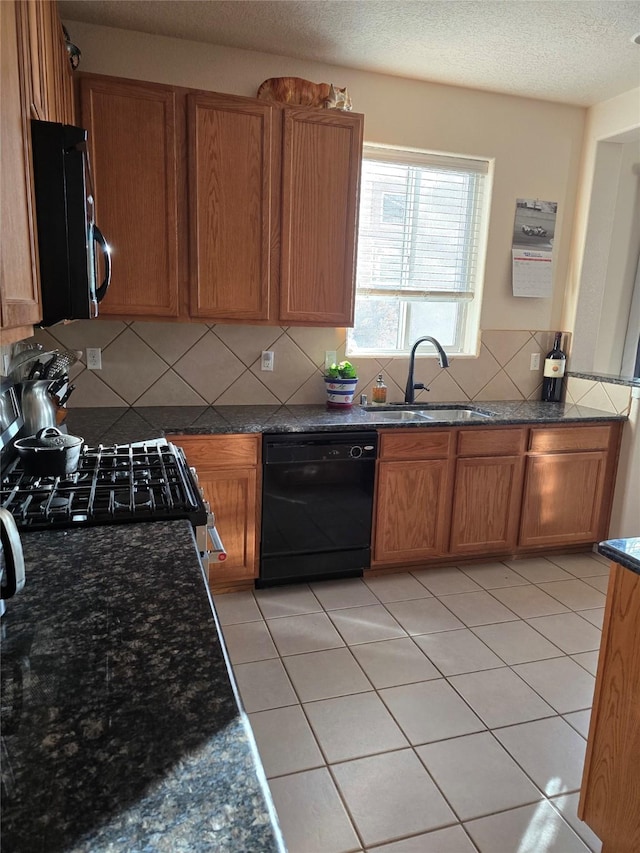 kitchen with dishwasher, backsplash, sink, stainless steel range, and light tile patterned flooring