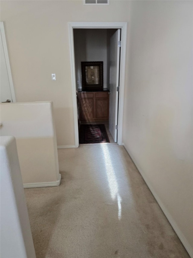 hallway with light carpet