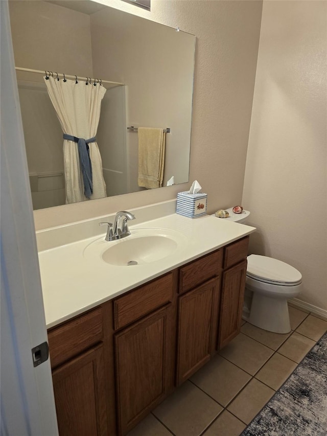 bathroom with tile patterned floors, vanity, and toilet