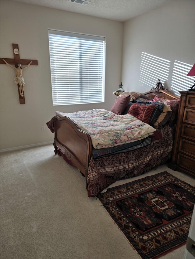 carpeted bedroom with a textured ceiling