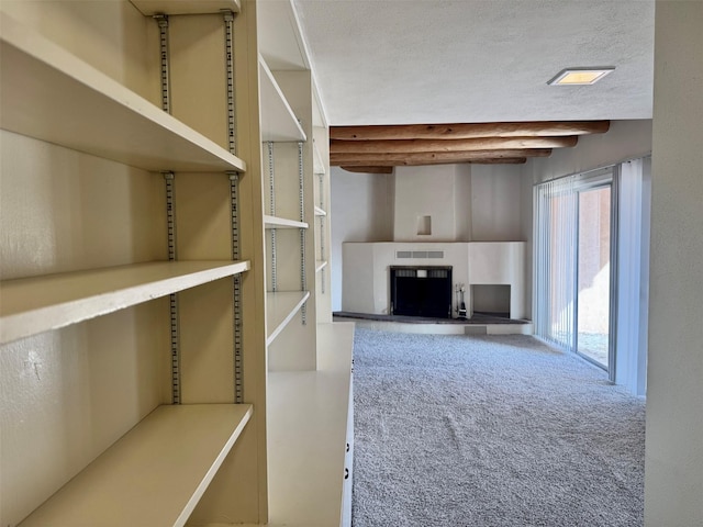 walk in closet with carpet flooring and beam ceiling