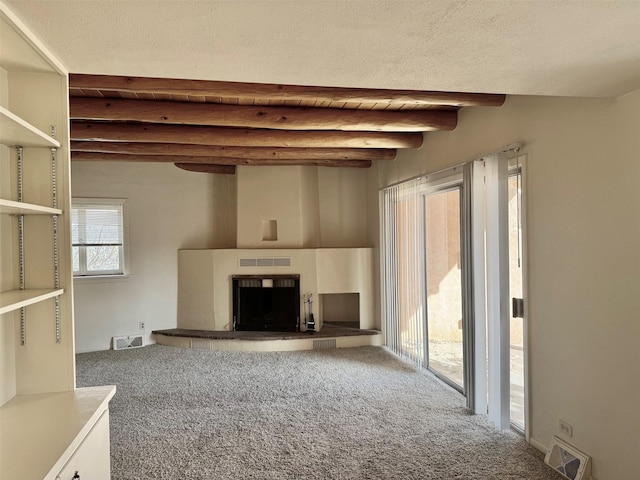 unfurnished living room featuring carpet floors, wooden ceiling, and beam ceiling