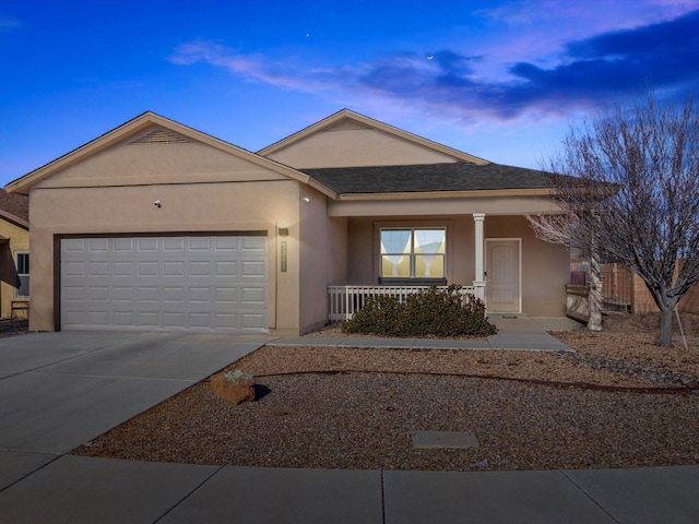 ranch-style home with covered porch and a garage