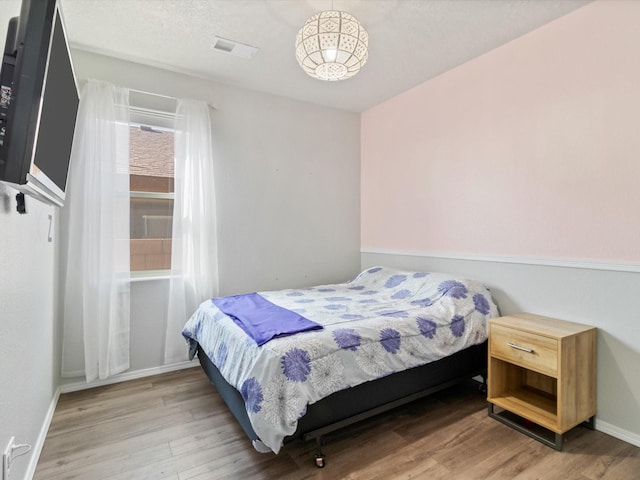 bedroom with hardwood / wood-style floors