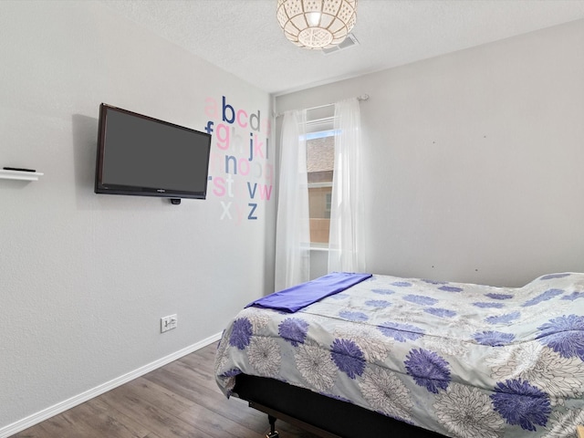 bedroom with hardwood / wood-style floors