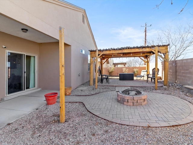 view of patio / terrace with a fire pit and a pergola