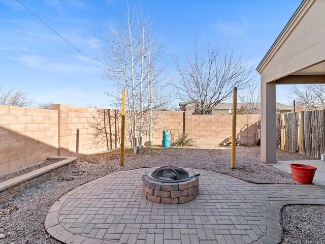 view of patio with an outdoor fire pit