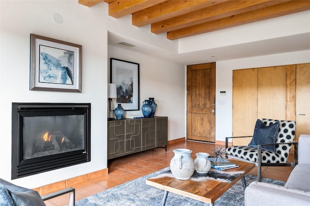 tiled living room featuring beam ceiling