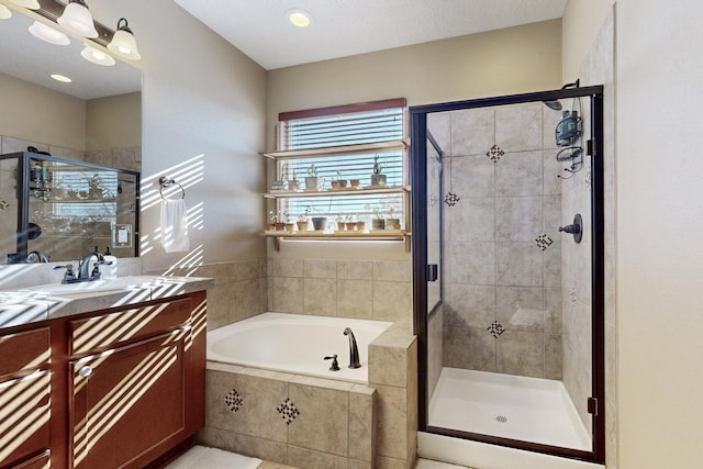 bathroom featuring vanity and shower with separate bathtub