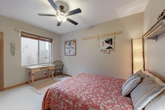 bedroom featuring ceiling fan, a textured ceiling, and carpet flooring