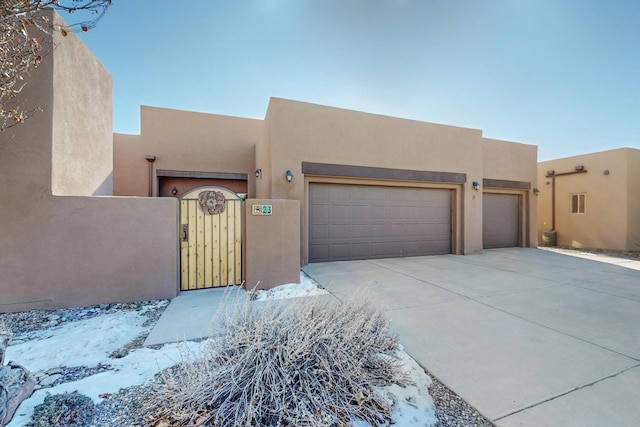 pueblo-style home with a garage