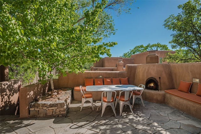 view of patio / terrace featuring exterior fireplace