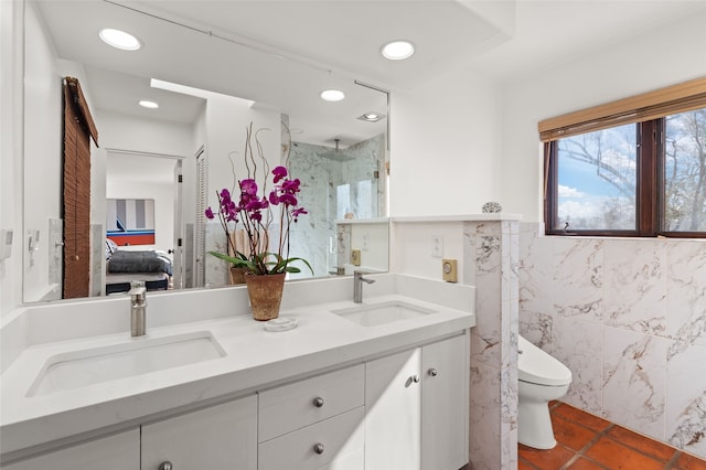 bathroom featuring walk in shower, tile patterned flooring, toilet, vanity, and tile walls