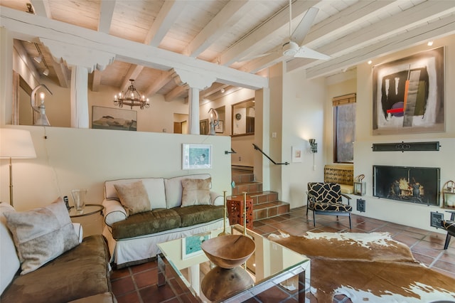 tiled living room featuring beamed ceiling, ceiling fan with notable chandelier, and wooden ceiling