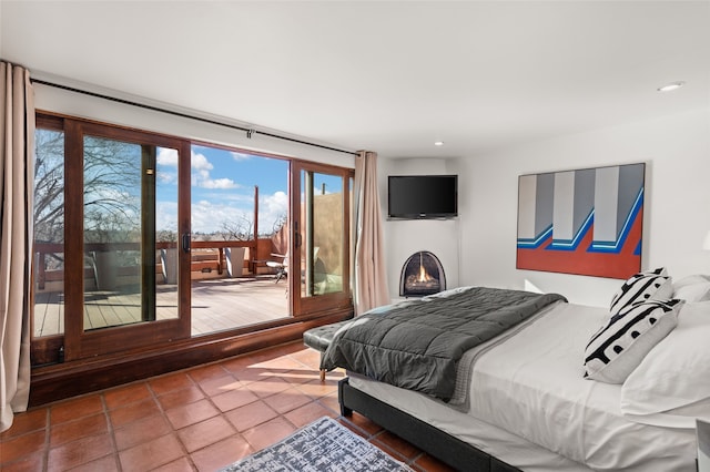 bedroom featuring tile patterned flooring and access to exterior