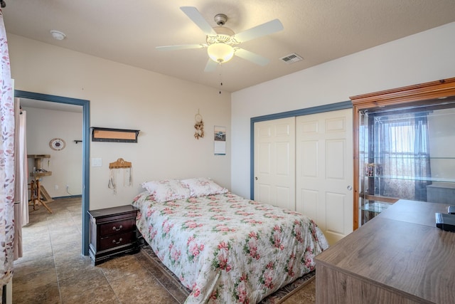 bedroom featuring ceiling fan and a closet