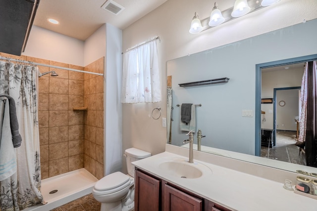 bathroom featuring vanity, a shower with shower curtain, and toilet