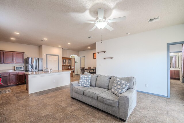 corridor with washer / clothes dryer and a textured ceiling