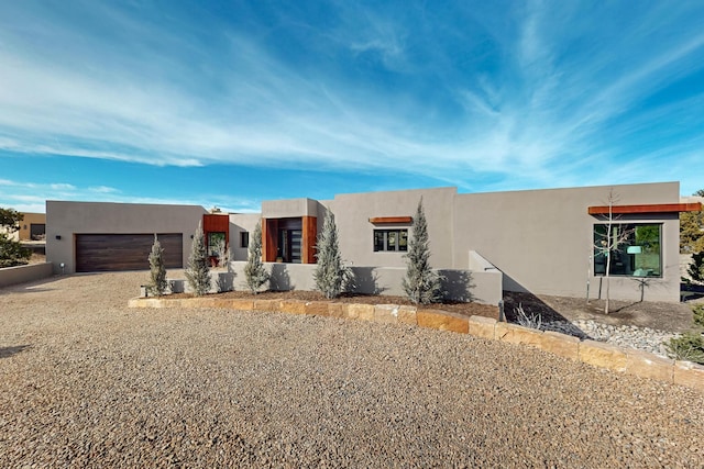 pueblo-style house with a garage