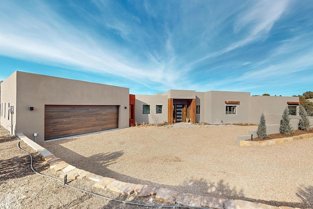 pueblo revival-style home with a garage