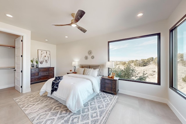 bedroom featuring ceiling fan and multiple windows