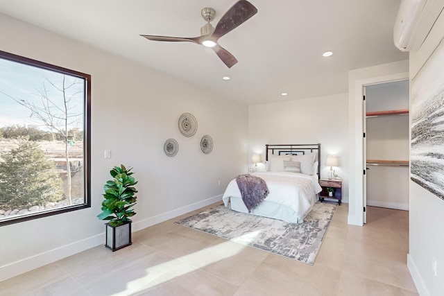 bedroom with a wall mounted air conditioner and ceiling fan