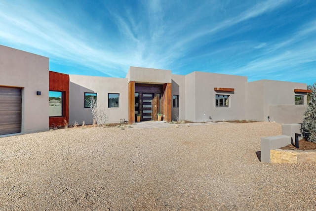 pueblo-style home featuring a garage