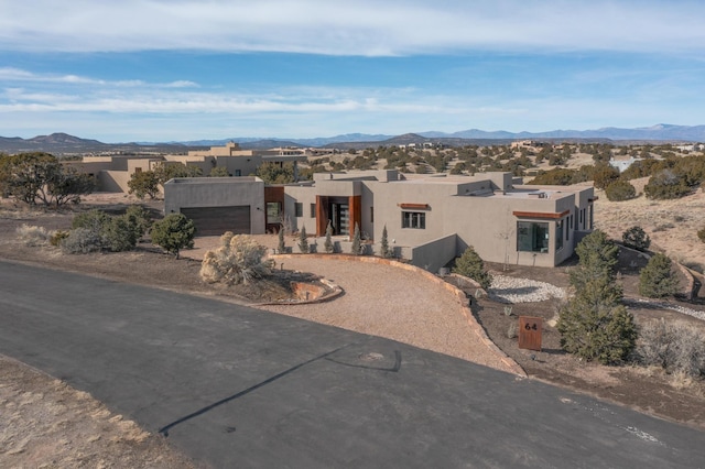 southwest-style home with a mountain view and a garage