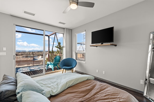 bedroom with access to exterior, ceiling fan, and dark hardwood / wood-style flooring