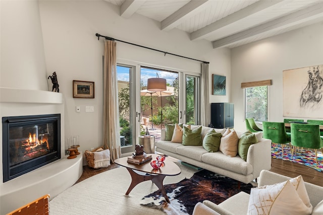 living room featuring a fireplace, beamed ceiling, and hardwood / wood-style flooring