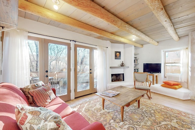 living room featuring wood ceiling, a healthy amount of sunlight, light hardwood / wood-style floors, and french doors