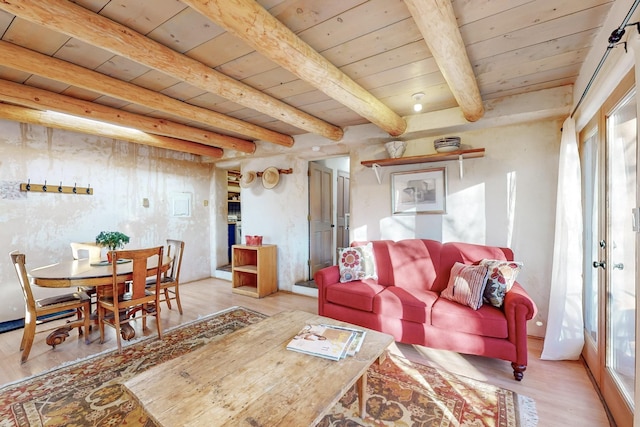 living room with beam ceiling, wooden ceiling, and light hardwood / wood-style floors