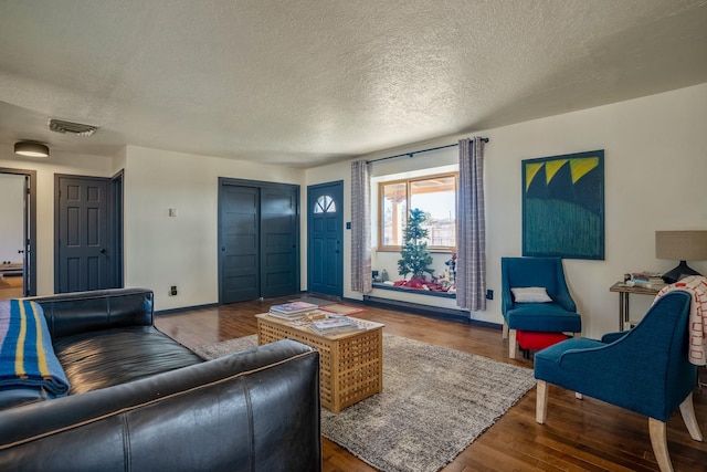 living room featuring a textured ceiling and hardwood / wood-style flooring