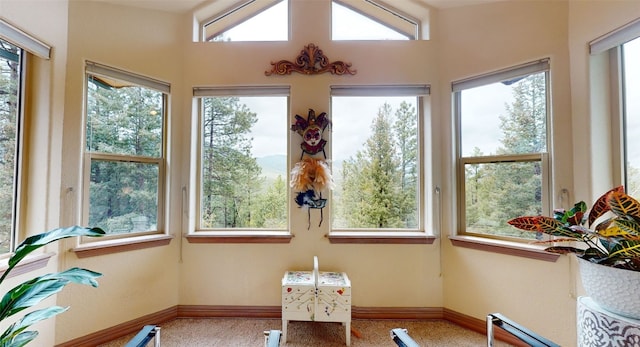 sunroom featuring lofted ceiling