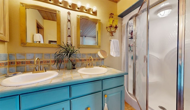 bathroom featuring decorative backsplash, an enclosed shower, and vanity