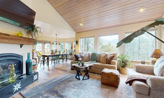 living room featuring hardwood / wood-style flooring, wood ceiling, and vaulted ceiling