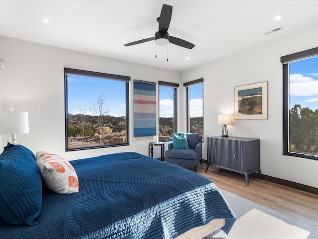 bedroom featuring ceiling fan and light hardwood / wood-style flooring