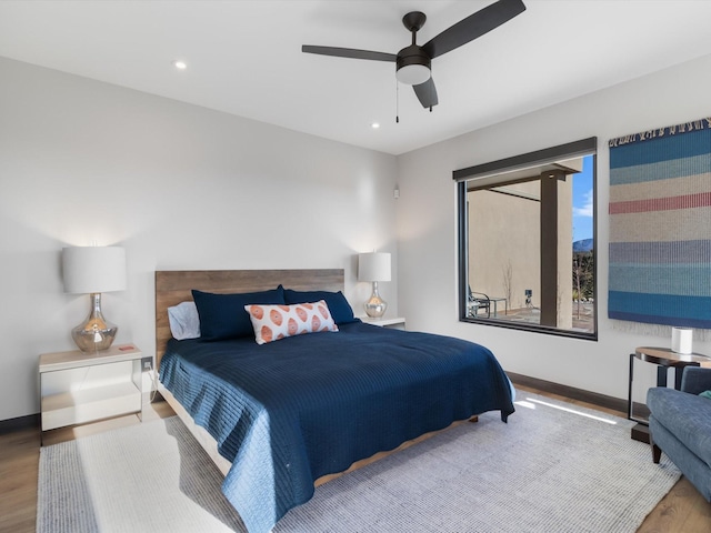 bedroom featuring wood-type flooring and ceiling fan