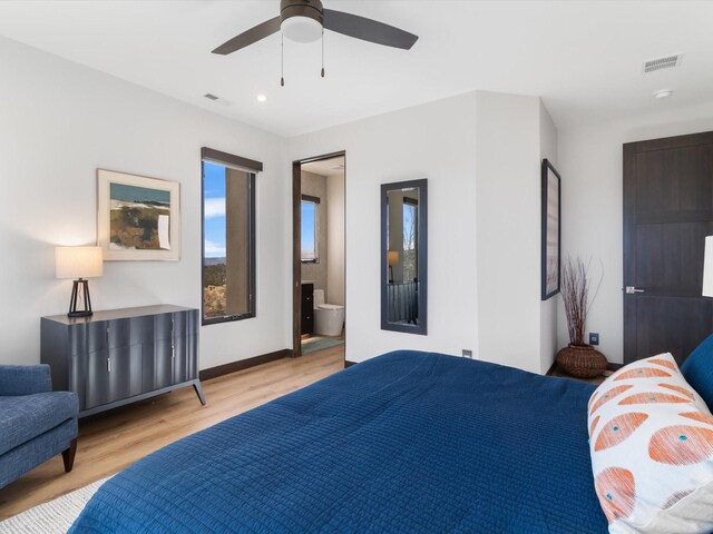 bedroom with connected bathroom, ceiling fan, and light hardwood / wood-style floors