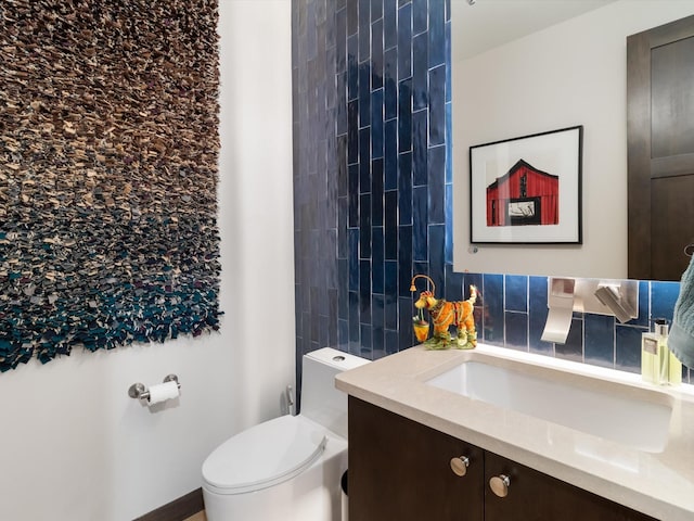 bathroom featuring decorative backsplash, toilet, and vanity