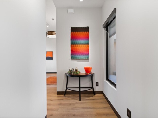 corridor with hardwood / wood-style floors