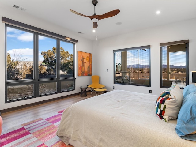 bedroom featuring hardwood / wood-style flooring and ceiling fan