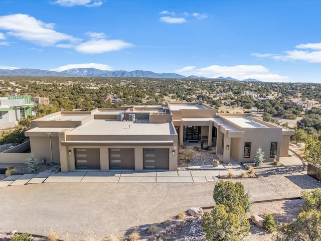 view of front of home featuring a mountain view and a garage