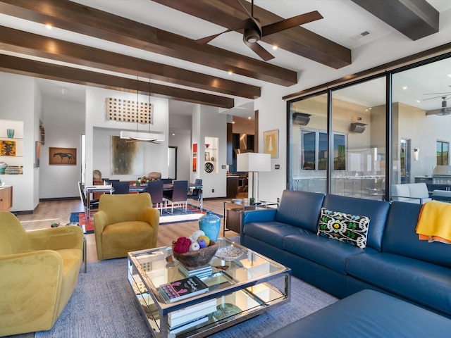 living room with beam ceiling, ceiling fan, and wood-type flooring